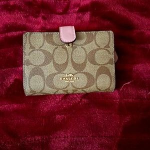 This is a pink and brown never used coach wallet